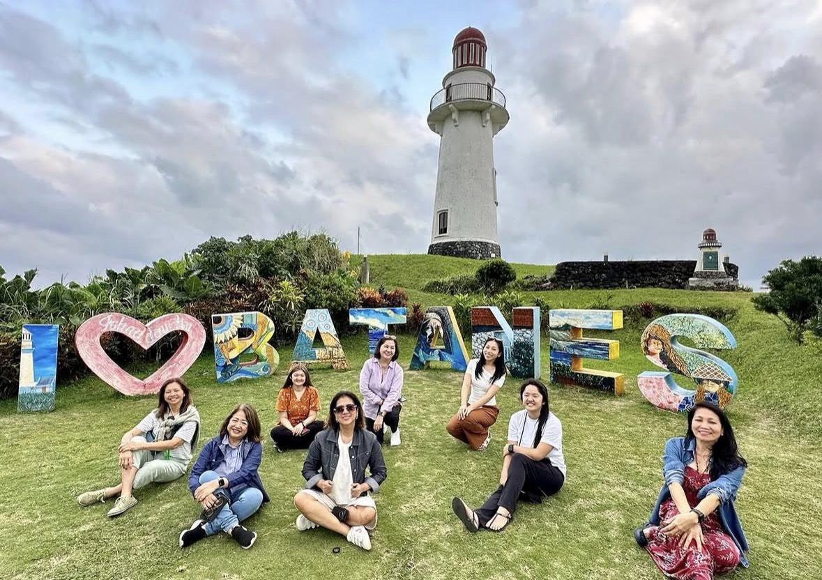 Scenic view of Batanes Island rolling green hills and stone houses on a Batanes tour package